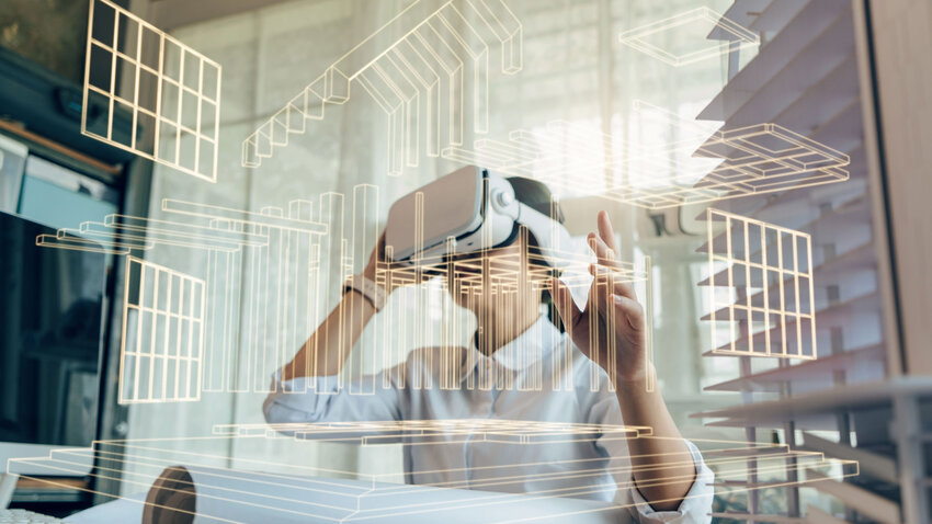 Mann steht mit VR-Brille in virtuellem Modell von Gebäuden